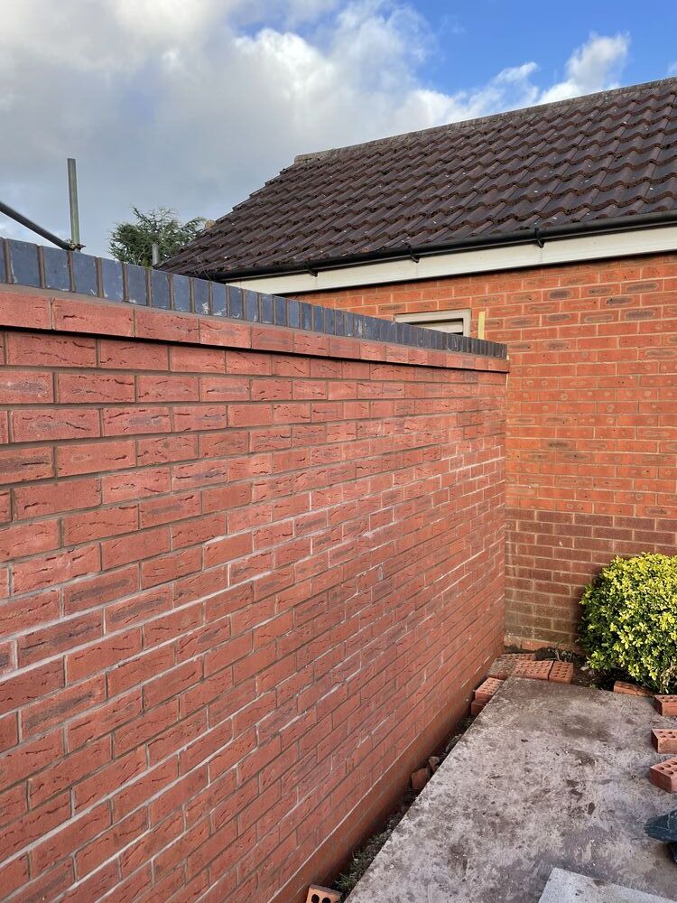 Detailed new red brick wall and contrasting course