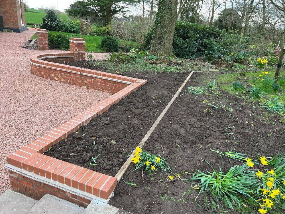 Curved garden wall finished with detailed brick coping