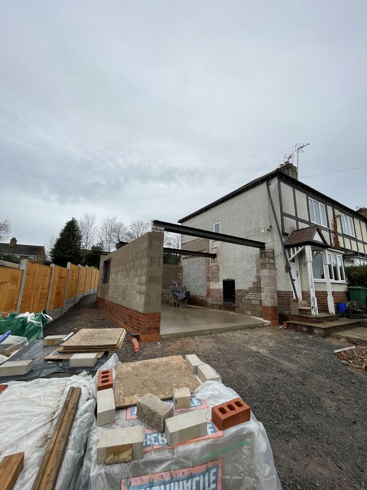 Extension build in progress with structure and roofline taking shape