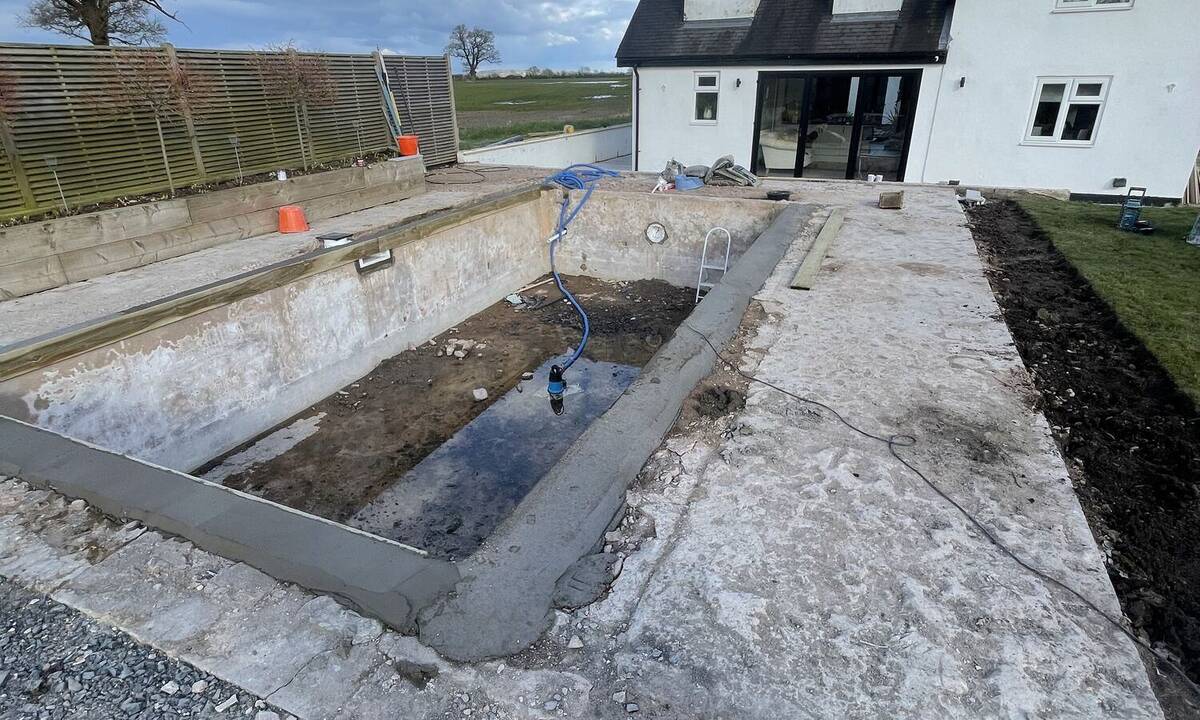 Pool and patio area during early landscaping construction