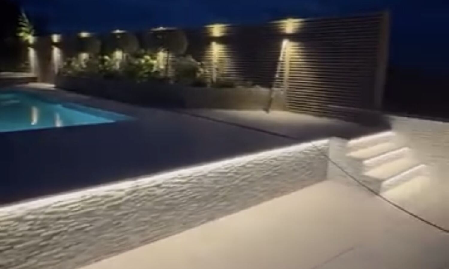 Completed poolside porcelain patio landscaping project
