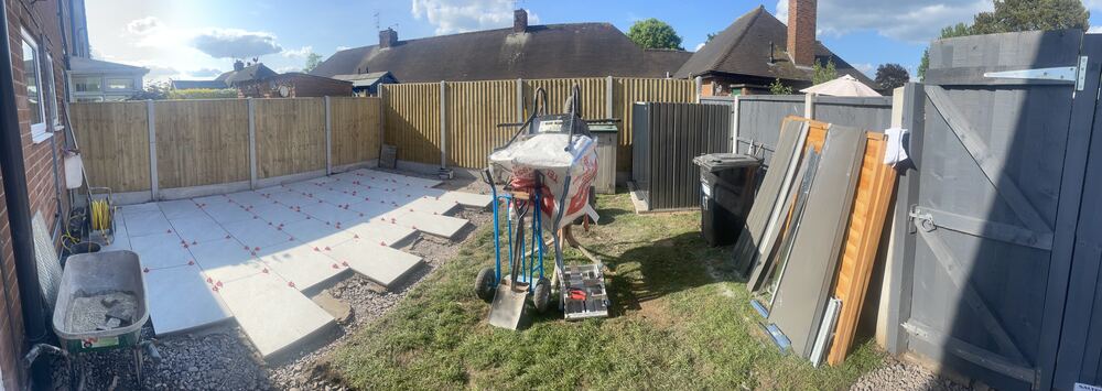 Wide landscaping project with patio and garden layout