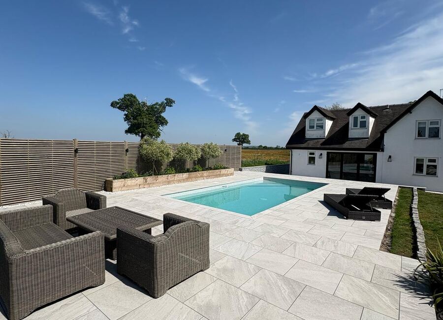 Finished poolside porcelain patio landscaping project in Telford